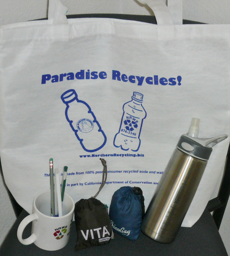 paradise recycling tote bag with bottles and mugs of merch