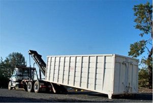 debris-box-rental being moved by truck